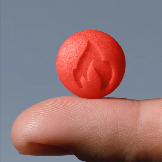 a SOCO Sparks sublingual drop standing on a finger